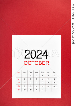 A October 2024 calendar page with push pin on red background. 116694337