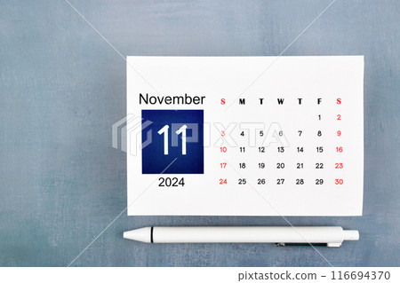 November Calendar 2024 page with pen on blue wooden. 116694370