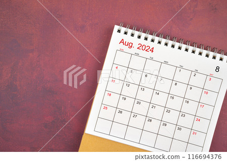 August 2024 desk calendar on red background. 116694376