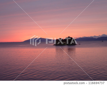 Evening view of Yomegashima, the only floating island on Lake Shinji, a brackish lake that straddles Matsue City and Izumo City in Shimane Prefecture. Evening view of Yomegashima, the only floating island on Lake Shinji, a brackish lake that straddles Matsue City and Izumo City in Shimane Prefecture. 116694737