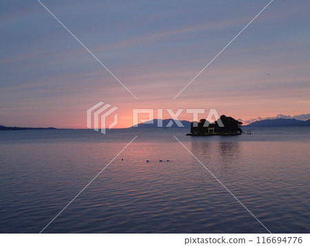 Evening view of Yomegashima, the only floating island on Lake Shinji, a brackish lake that straddles Matsue City and Izumo City in Shimane Prefecture. Evening view of Yomegashima, the only floating island on Lake Shinji, a brackish lake that straddles Matsue City and Izumo City in Shimane Prefecture. 116694776