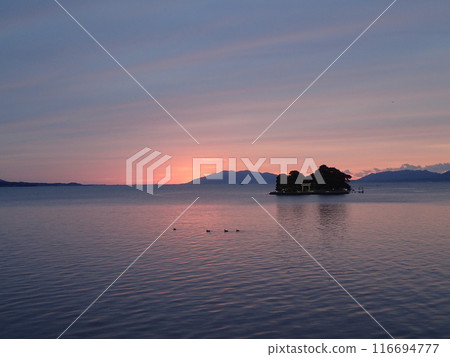 Evening view of Yomegashima, the only floating island on Lake Shinji, a brackish lake that straddles Matsue City and Izumo City in Shimane Prefecture. Evening view of Yomegashima, the only floating island on Lake Shinji, a brackish lake that straddles Matsue City and Izumo City in Shimane Prefecture. 116694777