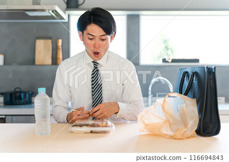 Asian male businessman eating lunch from a convenience store/supermarket (living alone, single, unhealthy, nutritionally balanced) 116694843