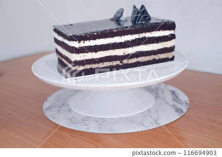 A rectangular layered chocolate cake with white cream layers A rectangular layered chocolate cake with white cream layers 116694903