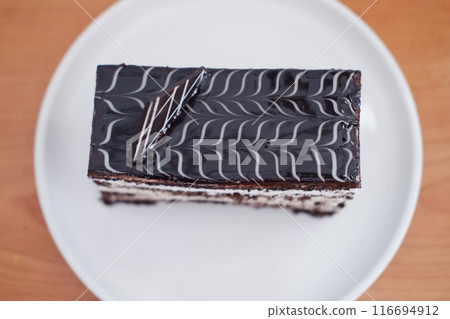 A rectangular layered chocolate cake with white cream layers A rectangular layered chocolate cake with white cream layers 116694912
