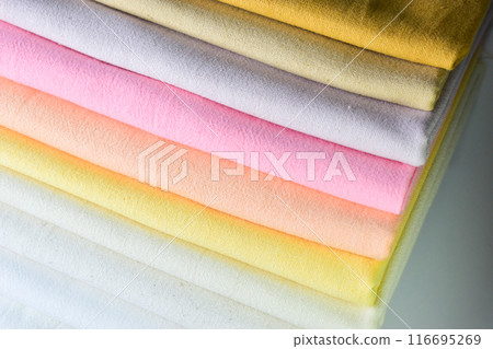 stack of colourful cotton clothes, pile of clothing on white background 116695269