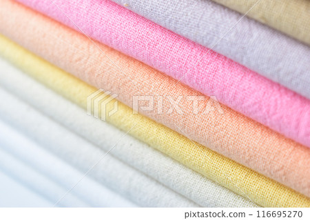 stack of colourful cotton clothes, close up pile of clothing 116695270
