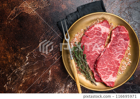 Alternative beef steak Denver, raw meat steak with herbs. Dark background. Top view. Copy space 116695971
