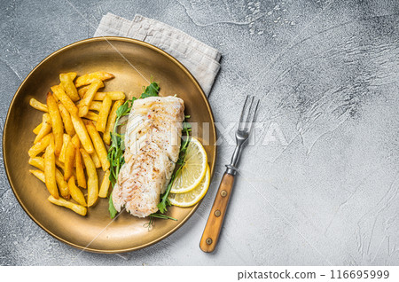 Fried cod fish fillet served with french fries. White background. Top view. Copy space 116695999