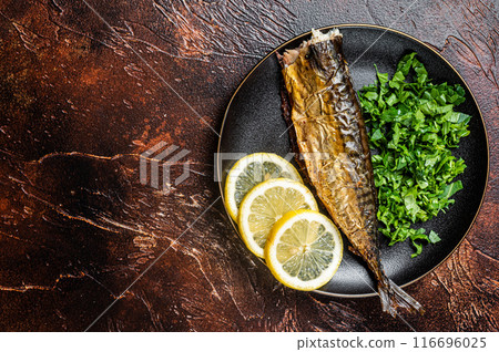 Grilled Mackerel Scomber fish on a plate with greens and lemon. Dark background. Top view. Copy space Grilled Mackerel Scomber fish on a plate with greens and lemon. Dark background. Top view. Copy space 116696025