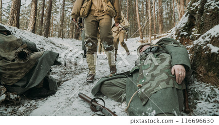 American Infantry Soldier Pass By Corpses Of German Soldiers. Live And Dead At War. Group Of Usa Soldiers On March After Battle. Fallen Dead German Soldiers American Infantry Soldier Pass By Corpses Of German Soldiers. Live And Dead At War. Group Of Usa Soldiers On March After Battle. Fallen Dead German Soldiers 116696630