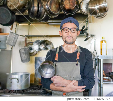 廚師在廚房裡拿著鍋 116697076