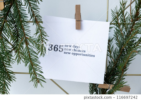 365 NEW DAYS CHANCES OPPORTUNITIES text on white paper note on vision board with Christmas decor. New year aims resolutions. New year New me 116697242