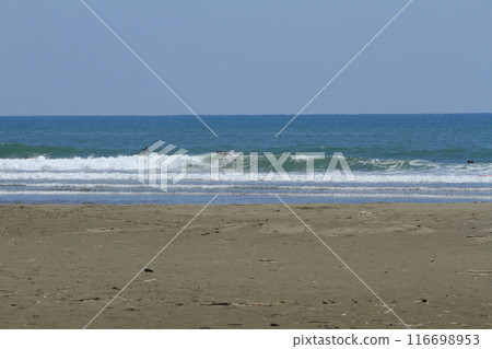 A surfer slicing through the big waves at Okuragahama Beach in Miyazaki 116698953