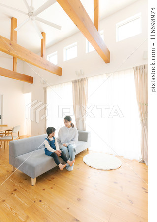 Parents and children relaxing in the living room 116698973