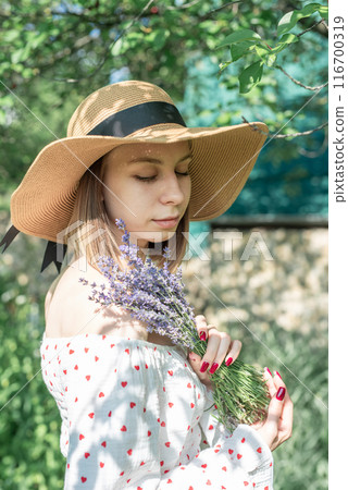 Young  woman picking lavender flowers 116700319