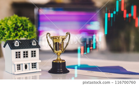 House model, pen and notepad on table with stock market chart, real estate market House model, pen and notepad on table with stock market chart, real estate market 116700760