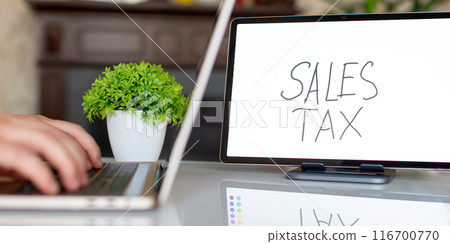Sales tax note. Business concept of the amount of money a company pays its employees, paying taxes 116700770