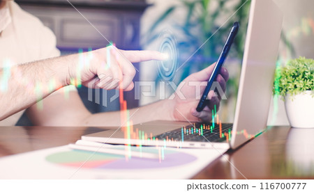 Businessman typing on laptop in office with double exposure of financial graph. 116700777
