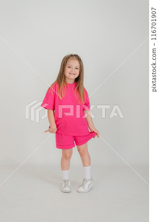 Little cute child kid baby girl 4-5 years old wearing light denim clothes isolated on wall background, children studio portrait. Mother's Day, love family, parenthood childhood concept 116701907