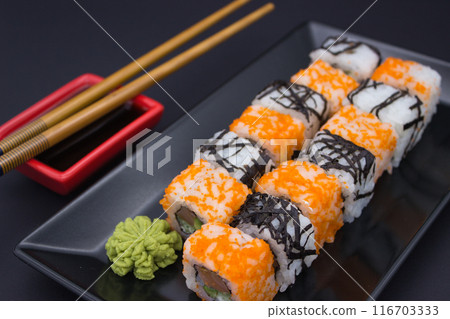 Sushi Composition with Soy Sauce and Wasabi on Dark Background 116703333