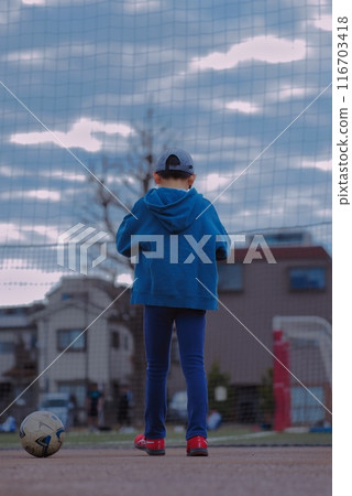 Boy chasing soccer ball Boy chasing soccer ball 116703418