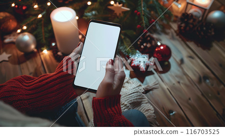 womans hands holding smartphone in rustic cafe blank white screen mockup wooden table background warm ambient lighting 116703525