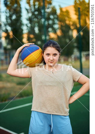 Lifestyle portrait of little girl ten years old holding game ball 116703561