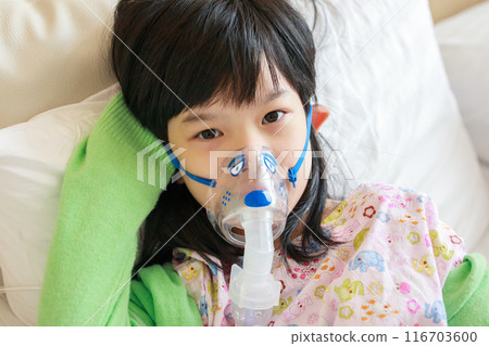 Sick little asian girl inhalation with nebulizer for respiratory treatment 116703600