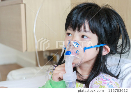 Sick little asian girl inhalation with nebulizer for respiratory treatment Sick little asian girl inhalation with nebulizer for respiratory treatment 116703612