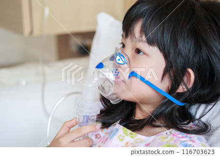 Sick little asian girl inhalation with nebulizer for respiratory treatment 116703623