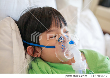 Sick little asian girl inhalation with nebulizer for respiratory treatment Sick little asian girl inhalation with nebulizer for respiratory treatment 116703637