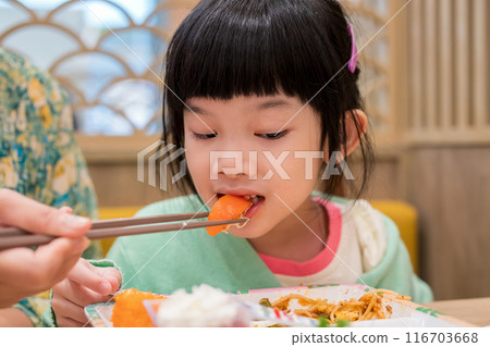 Cute little asian child girl eating food Cute little asian child girl eating food 116703668