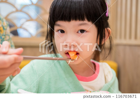 Cute little asian child girl eating food Cute little asian child girl eating food 116703671