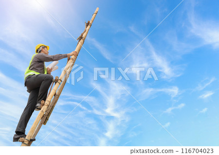 Asian business man engineer climbing up ladder with blue sky, career growth and success concept 116704023