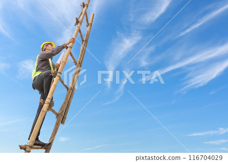 Asian business man engineer climbing up ladder with blue sky, career growth and success concept Asian business man engineer climbing up ladder with blue sky, career growth and success concept 116704029
