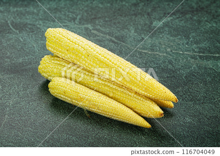 Raw sweet baby corn heap 116704049