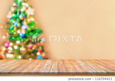Empty wood table top with blur Christmas tree with bokeh light background 116704421