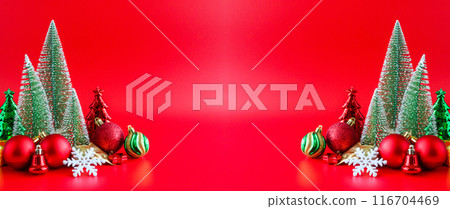Christmas tree and baubles on red background new year holiday celebration concept Christmas tree and baubles on red background new year holiday celebration concept 116704469