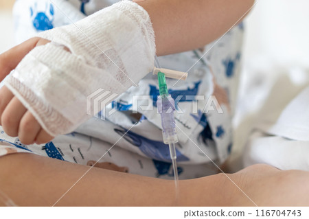 Close up child hand with saline IV solution in hospital Close up child hand with saline IV solution in hospital 116704743