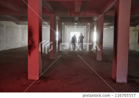 An abandoned building serves as the stronghold for a team of terrorists, fiercely guarding their occupied territory with guns and military equipment An abandoned building serves as the stronghold for a team of terrorists, fiercely guarding their occupied territory with guns and military equipment 116705557