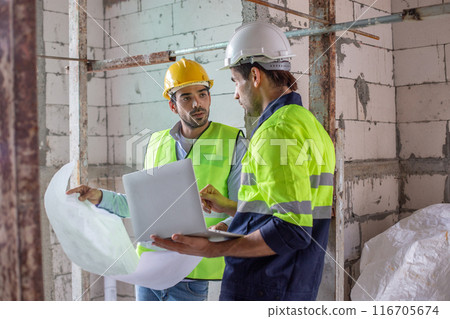 man engineer builder house construction holding blueprint drawing. 116705674