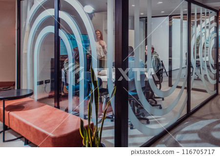 A group of young business entrepreneurs engages in a focused meeting, discussing various business strategies and collaboratively solving challenging problems, showcasing ambition, creativity, and 116705717