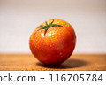 A tomato on a chopping board 116705784