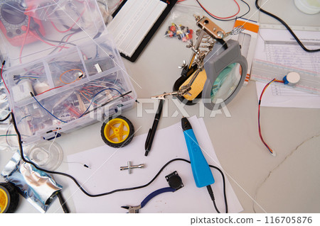 Various components and installations for robot fabrication fill the space, representing the intricate blend of technology, engineering, and innovation involved in the development and assembly of 116705876