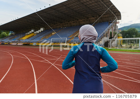 A muslim woman in a burqa sports muslim clothes running on a marathon course and preparing for upcoming competitions A muslim woman in a burqa sports muslim clothes running on a marathon course and preparing for upcoming competitions 116705879