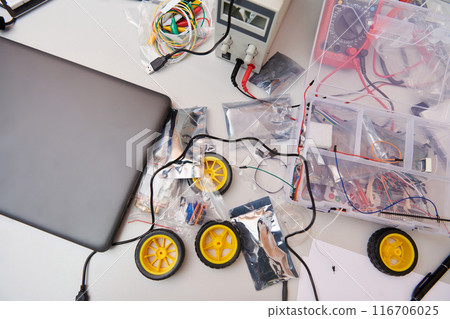 Various components and installations for robot fabrication fill the space, representing the intricate blend of technology, engineering, and innovation involved in the development and assembly of Various components and installations for robot fabrication fill the space, representing the intricate blend of technology, engineering, and innovation involved in the development and assembly of 116706025