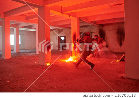 A group of professional soldiers bravely executes a dangerous rescue mission, surrounded by fire in a perilous building. A group of professional soldiers bravely executes a dangerous rescue mission, surrounded by fire in a perilous building. 116706118
