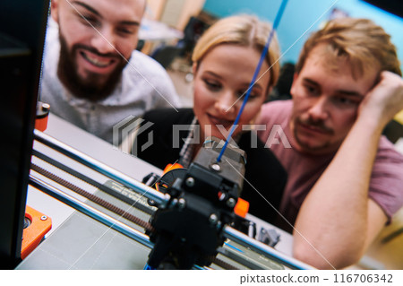 A group of colleagues working together in a robotics laboratory, focusing on the intricate fields of robotics and 3D printing. Showcase their dedication to innovation, as they engage in research A group of colleagues working together in a robotics laboratory, focusing on the intricate fields of robotics and 3D printing. Showcase their dedication to innovation, as they engage in research 116706342