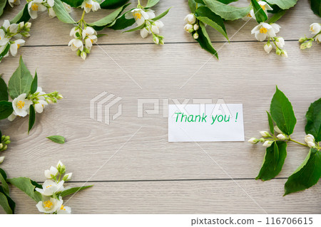 wooden light background with white jasmine flowers 116706615